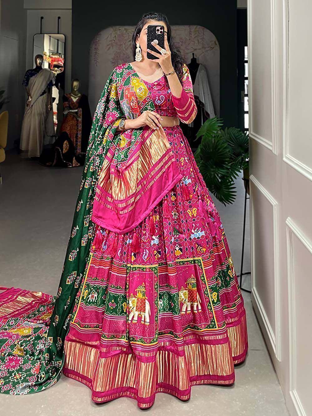 Vibrant pink and green printed lehenga choli with elephant motifs, perfect for Indian ethnic wear occasions.