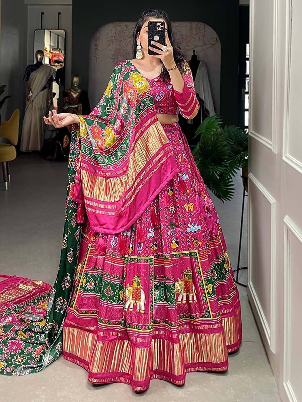 Vibrant pink and green printed lehenga choli with elephant motifs, perfect for Indian ethnic wear occasions