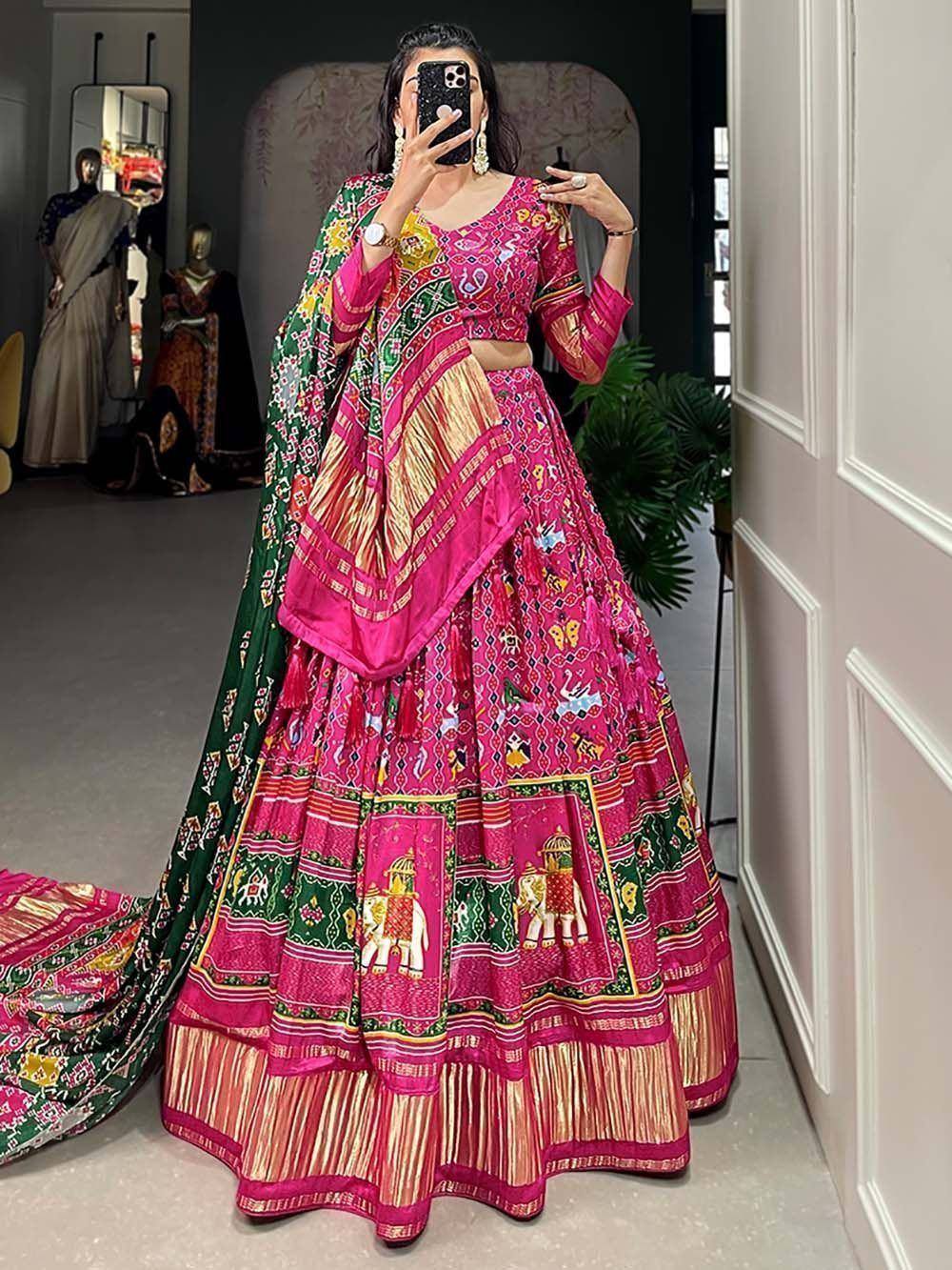 Vibrant pink and green printed lehenga choli with elephant motifs, perfect for Indian ethnic wear occasions