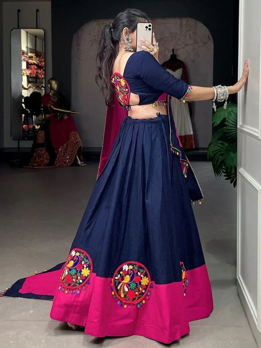 Navy blue lehenga with pink border and floral embroidery, back view with mirror selfie