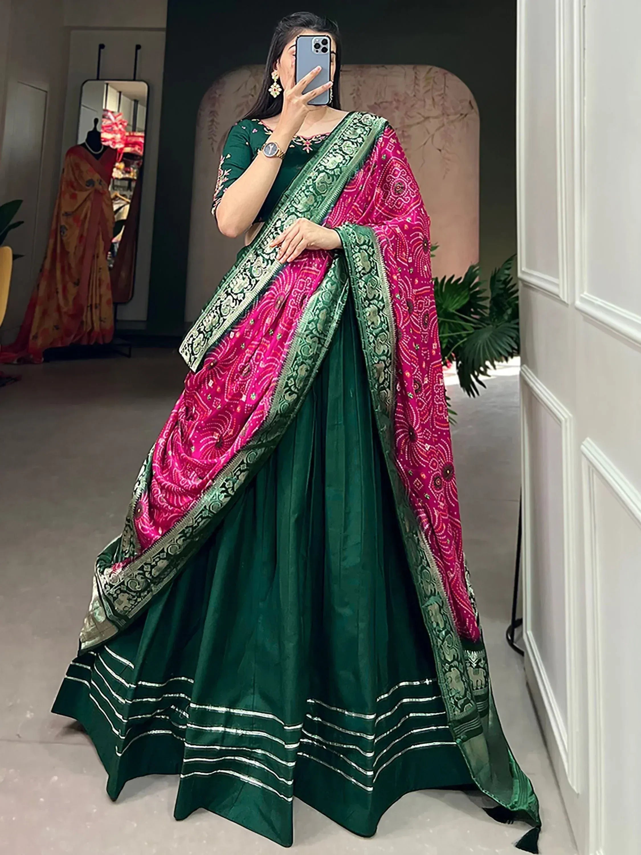 Woman in green lehenga choli with pink embroidered dupatta, Indian ethnic wear