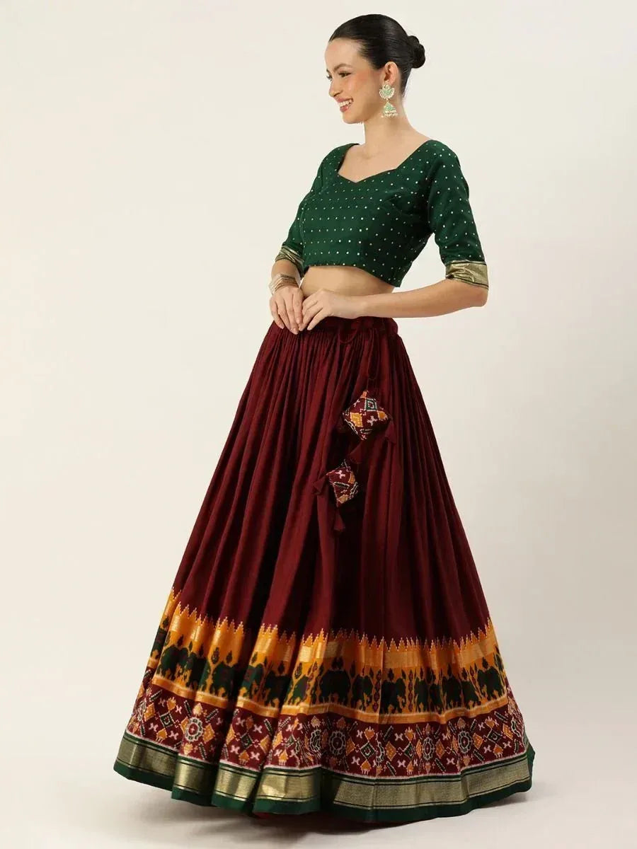 Green polka dot crop top with maroon pleated lehenga featuring elephant print border, ethnic wear