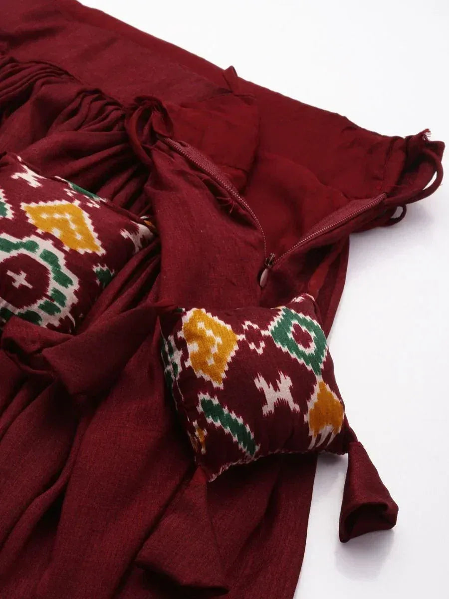 Maroon ethnic gown with ikat patterned pockets and drawstring waist, perfect for Indian festive wear