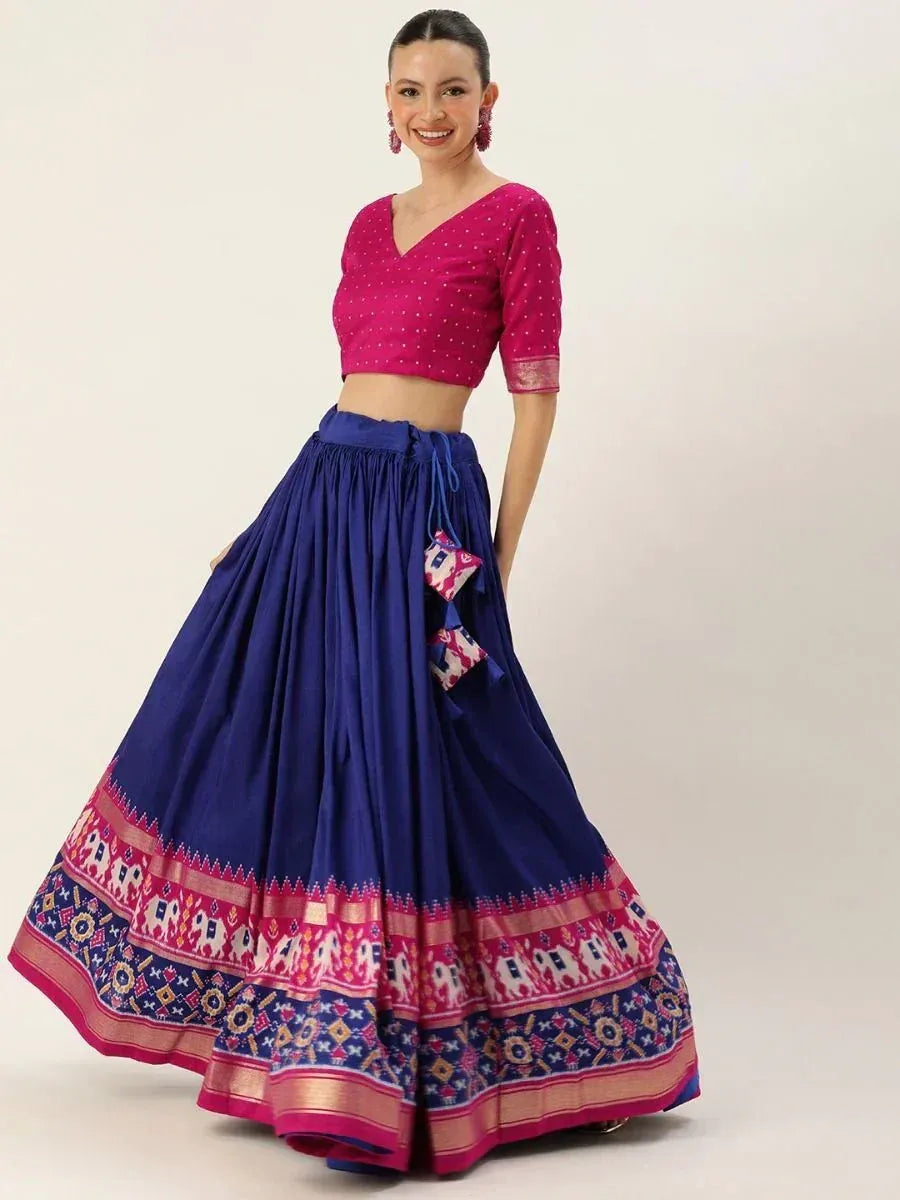 Woman in pink crop top and navy blue lehenga with elephant print border, ethnic Indian wear