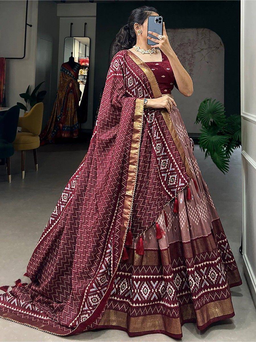 Maroon printed lehenga choli with gold border and tassels, ethnic Indian wear for women