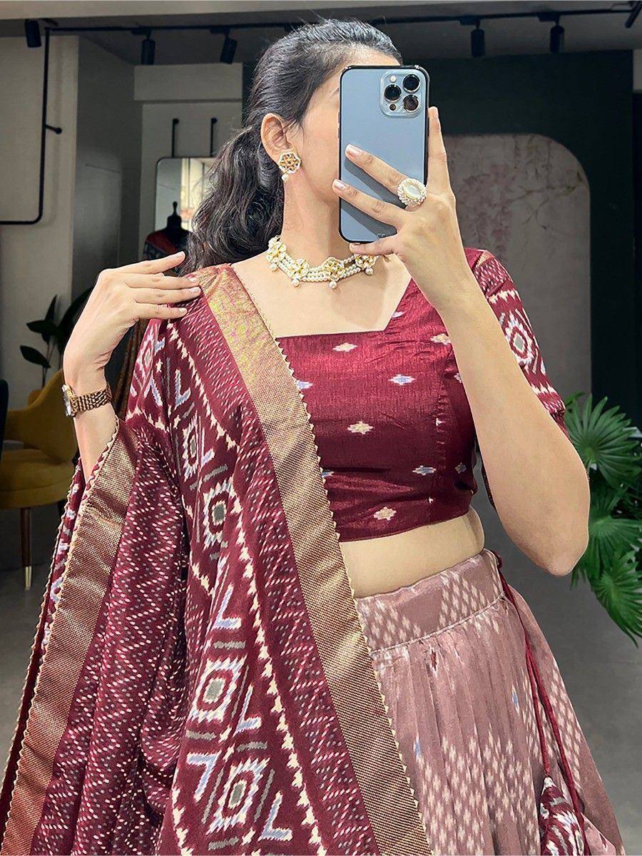 Maroon ikat lehenga choli with geometric print, pearl jewelry, perfect for Indian ethnic occasions
