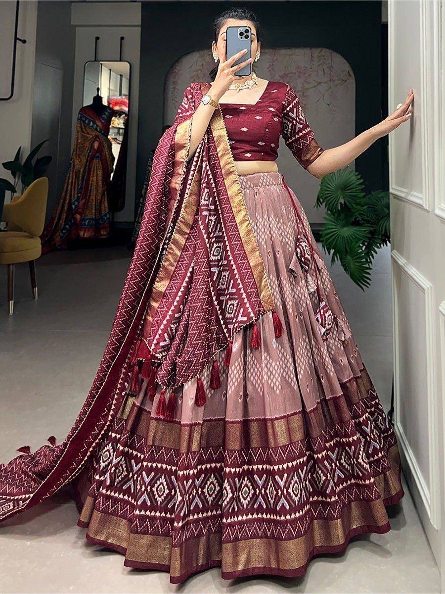 Maroon and pink printed lehenga choli with geometric patterns and gold trim, perfect for Indian ethnic wear