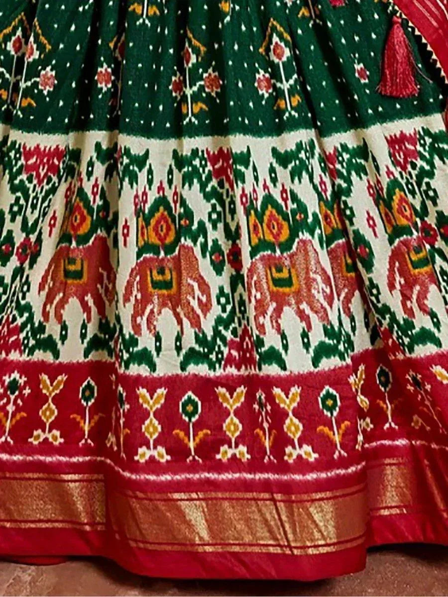 Green and red ethnic lehenga with elephant print and gold border, traditional Indian wedding wear