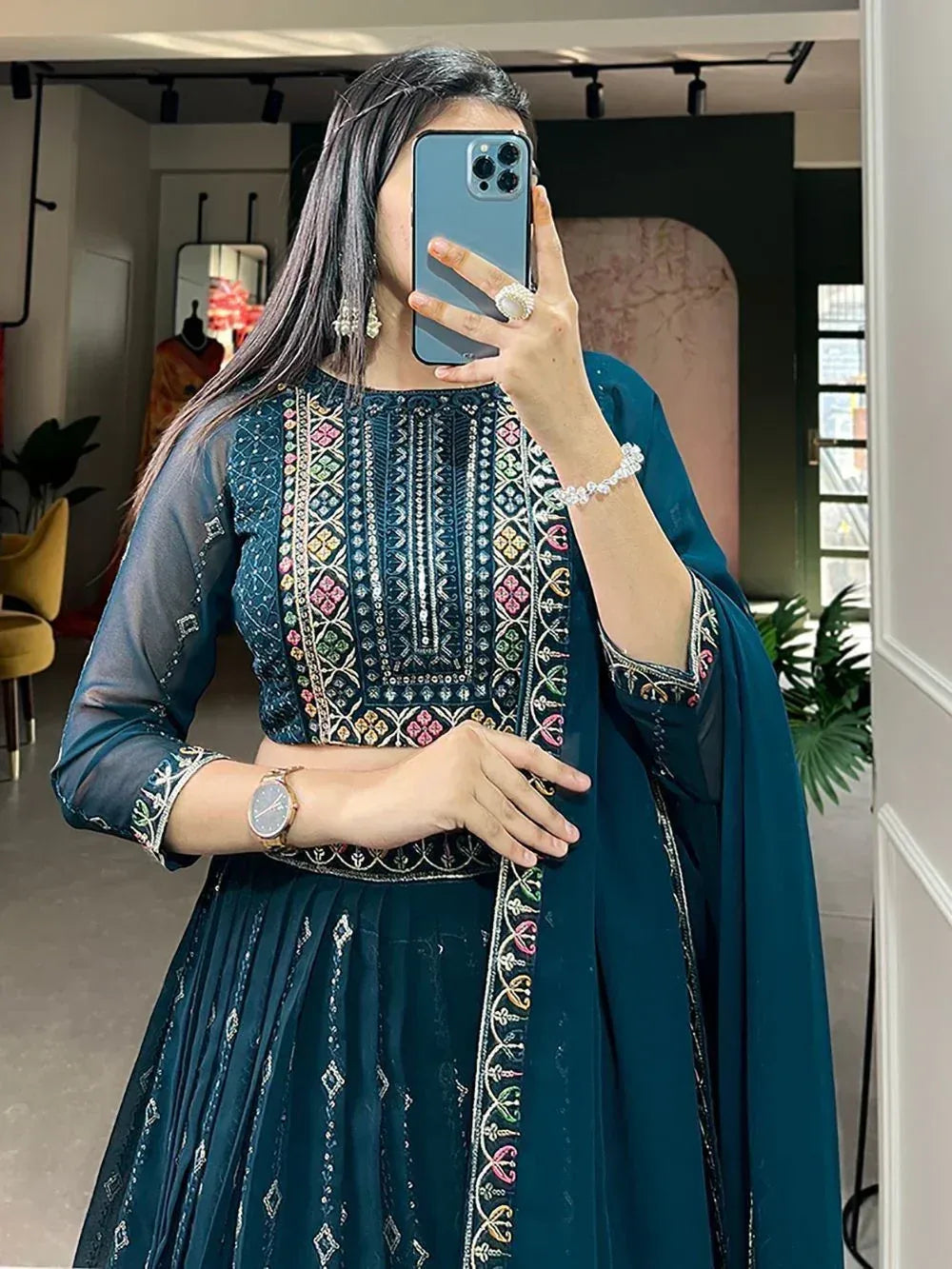 Teal embroidered lehenga choli with sheer sleeves, perfect for Indian ethnic wear occasions