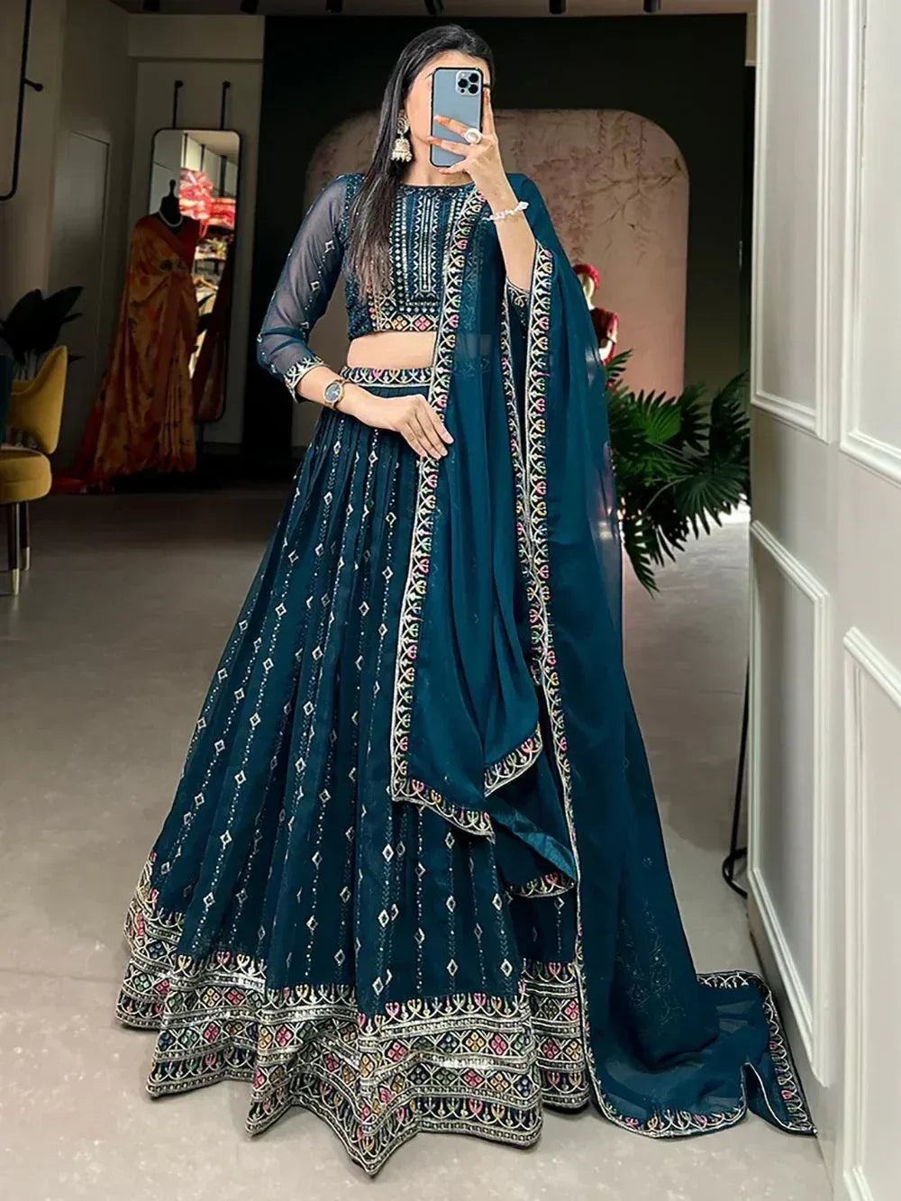 Teal embroidered lehenga choli with sheer sleeves and dupatta, perfect for Indian ethnic wear occasions