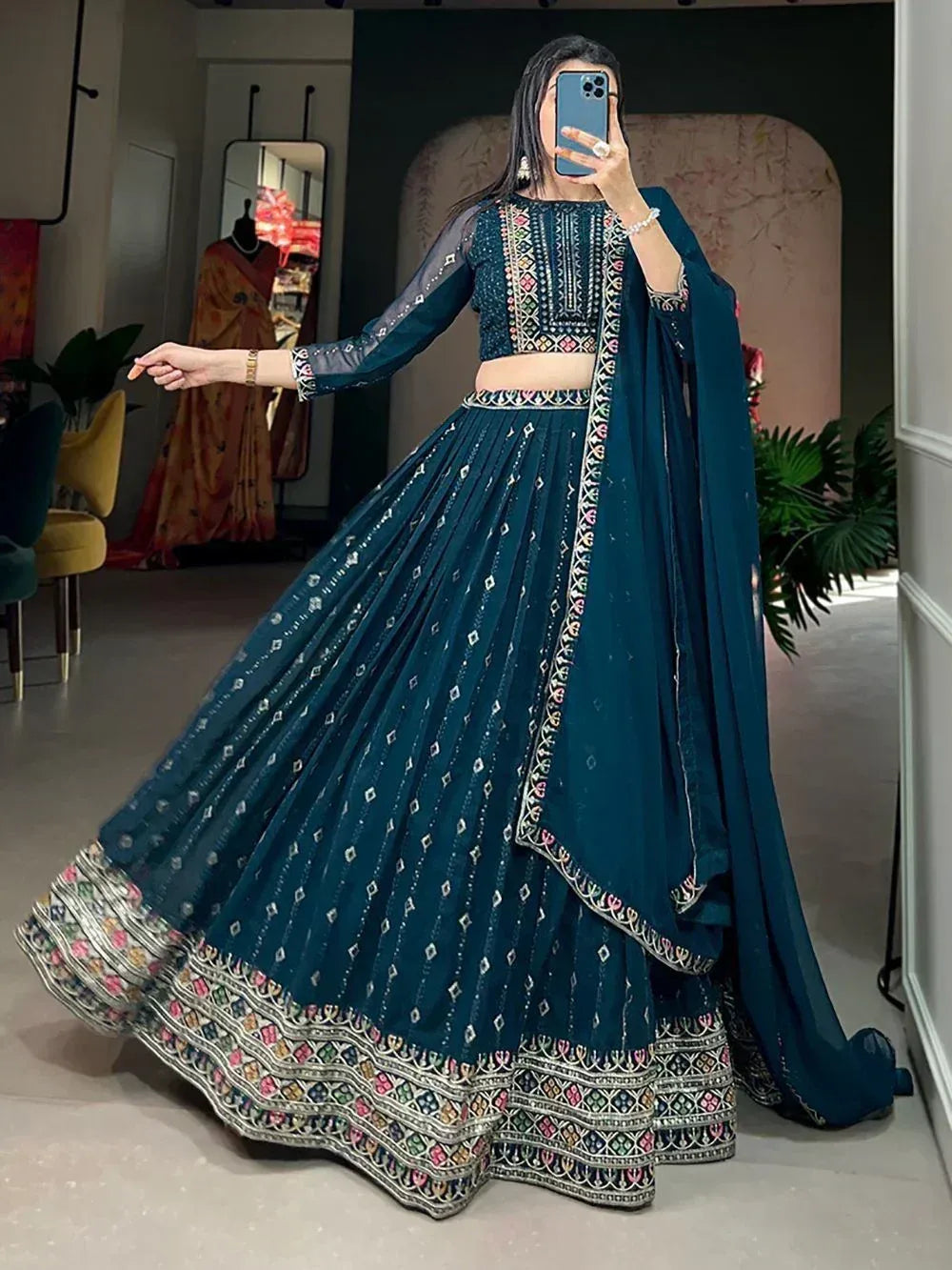 Teal embroidered lehenga choli with sheer sleeves and floral border, perfect for Indian ethnic occasions