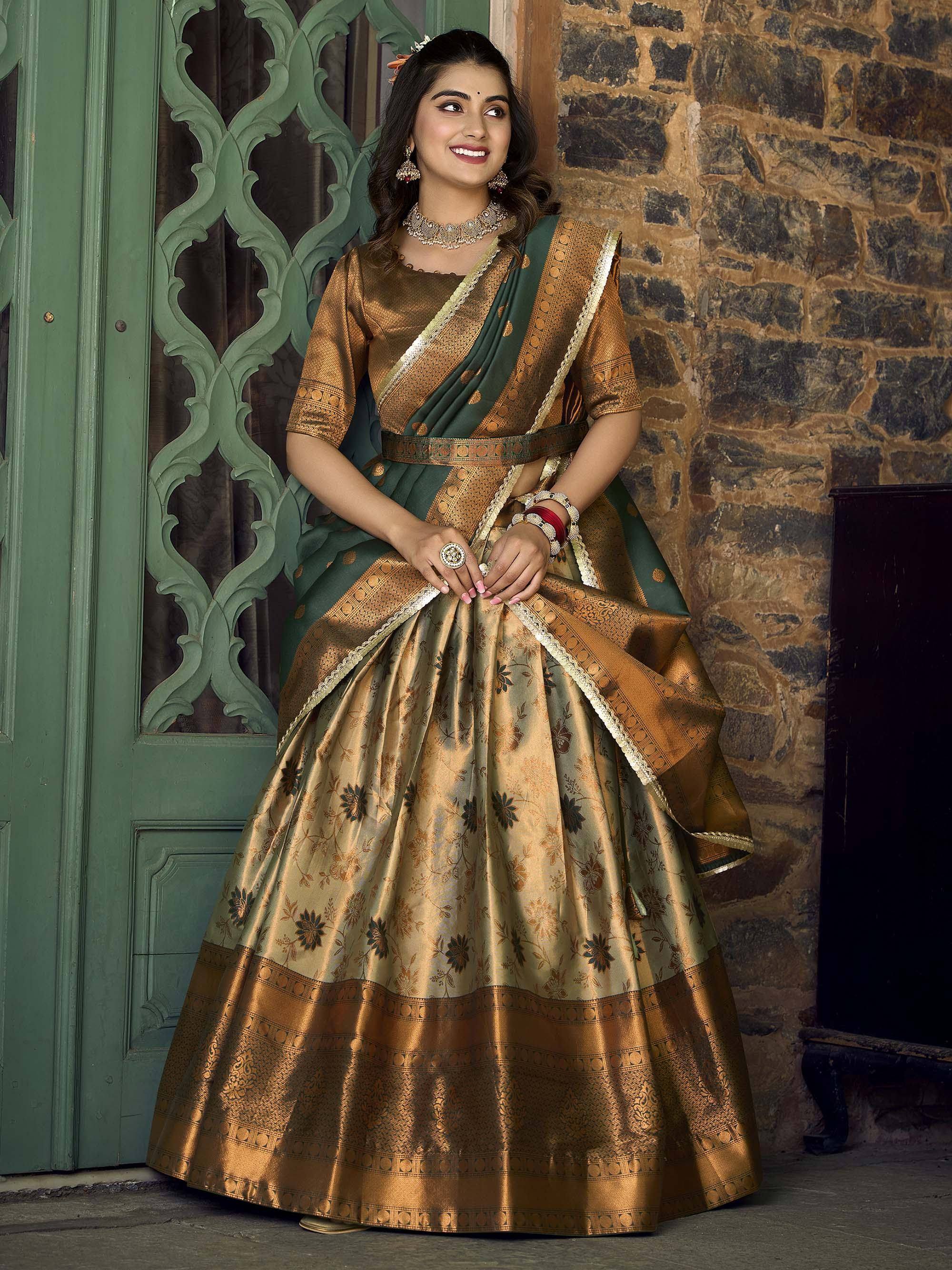 Woman in elegant green and gold designer lehenga choli with floral print, perfect for Indian ethnic wear occasions.