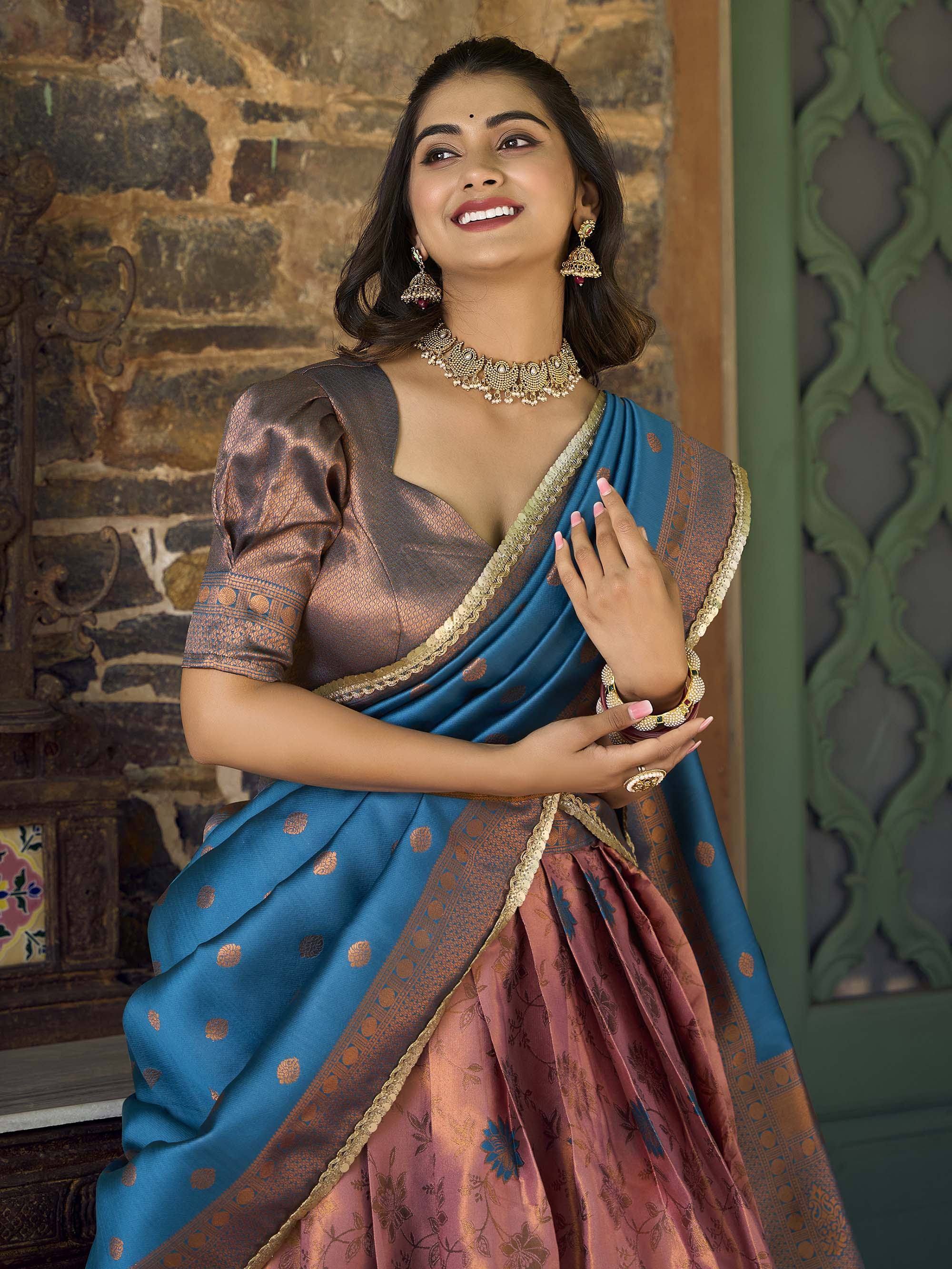 Woman in blue and bronze designer saree with gold border, traditional Indian ethnic wear