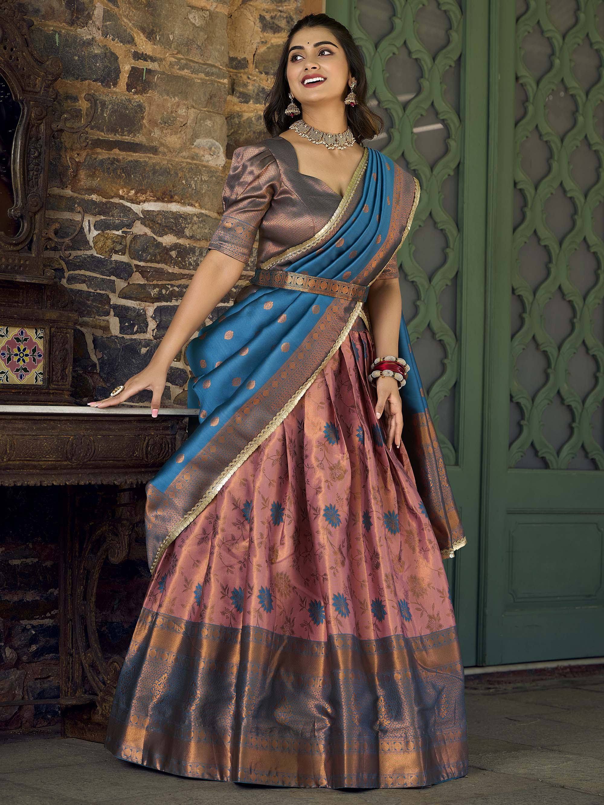 Elegant Indian designer lehenga choli with blue and pink floral silk, gold border, traditional jewelry