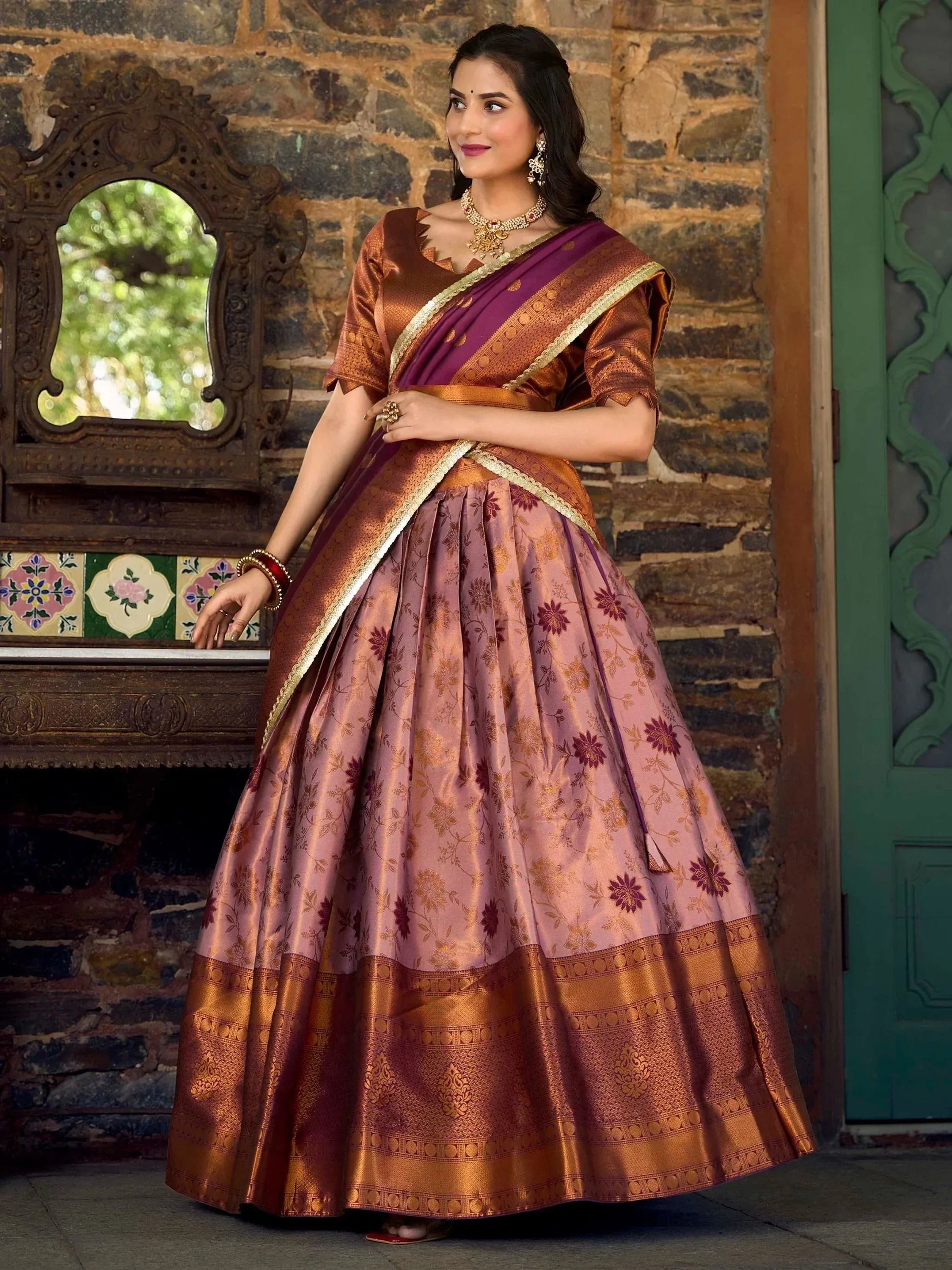 Elegant purple and gold floral lehenga choli with traditional Indian embroidery and border design