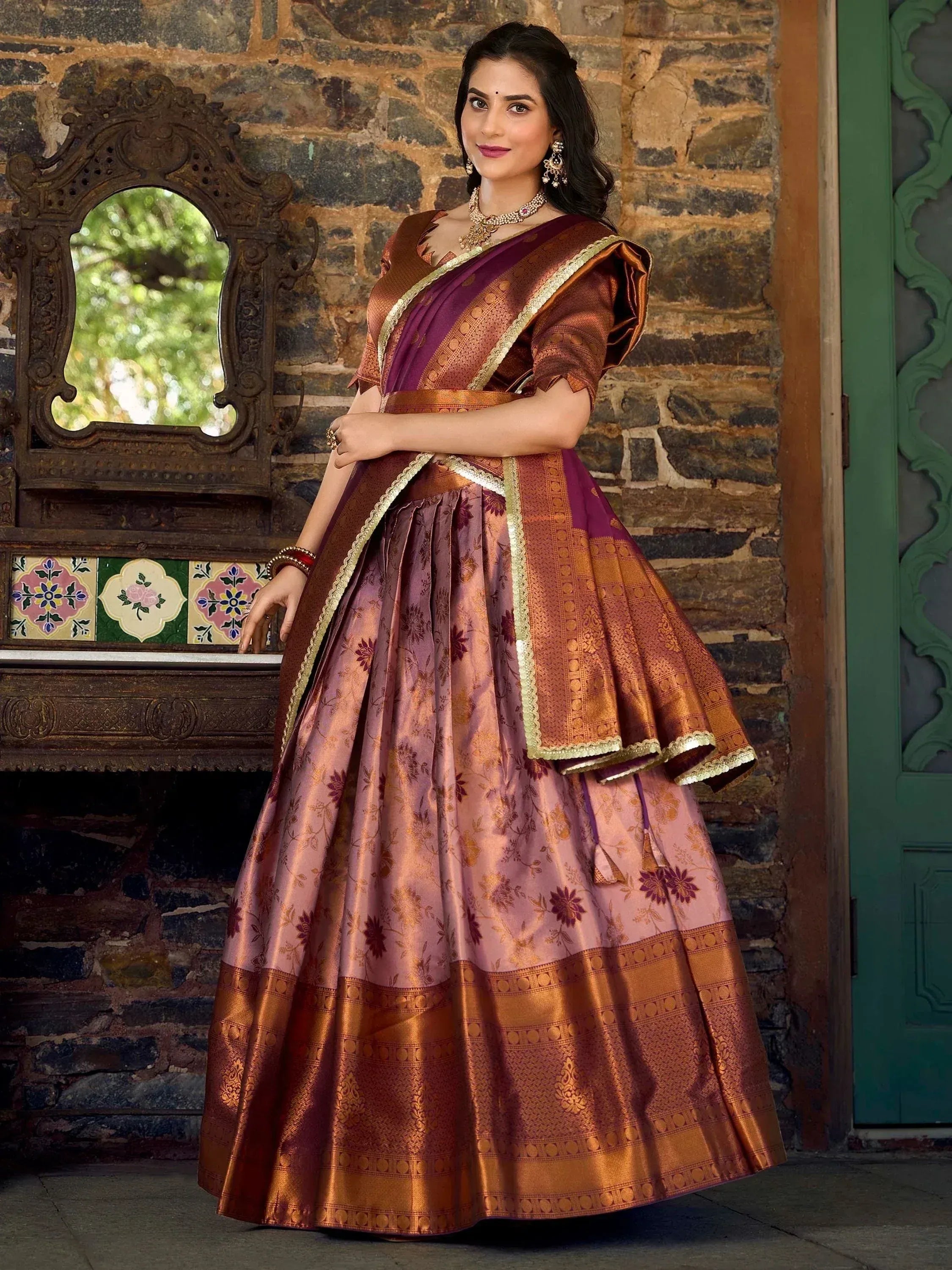 Elegant Indian ethnic lehenga choli with floral patterns and gold borders, perfect for festive occasions.