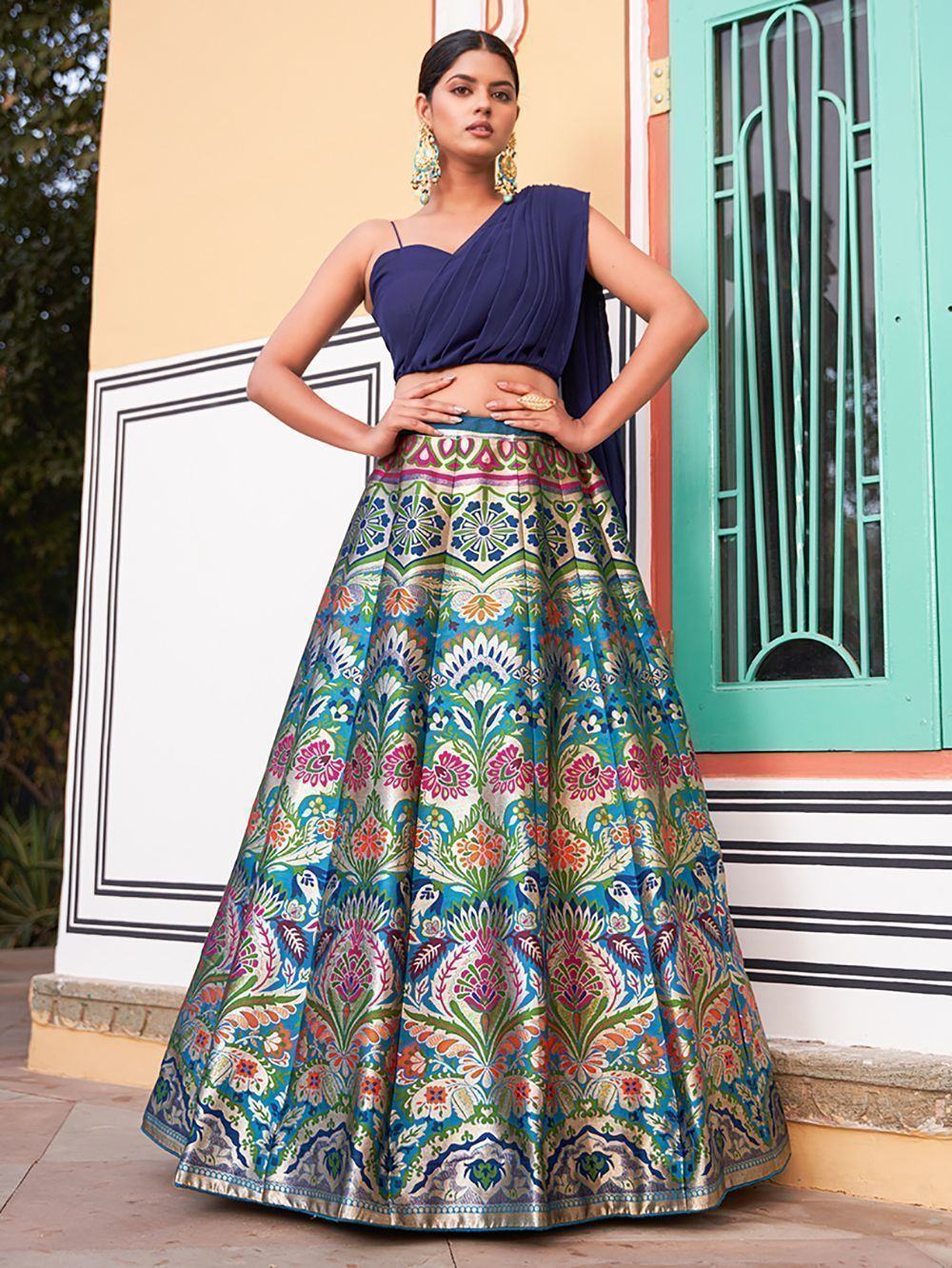 Blue one-shoulder lehenga choli with vibrant floral print skirt, perfect for Indian ethnic wear occasions