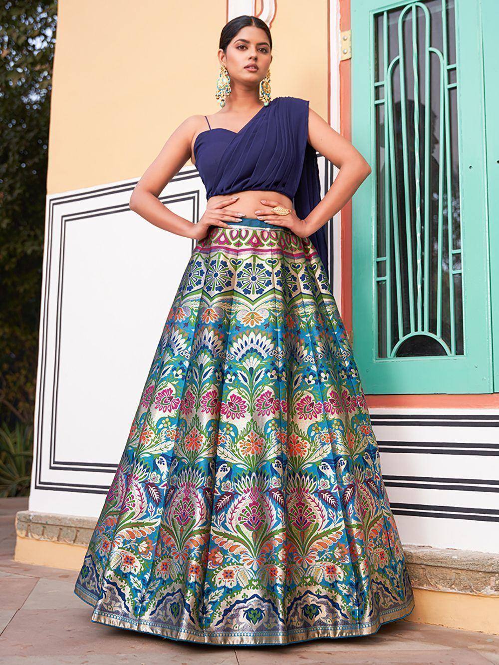 Blue one-shoulder lehenga choli with vibrant floral print skirt, perfect for Indian ethnic wear occasions