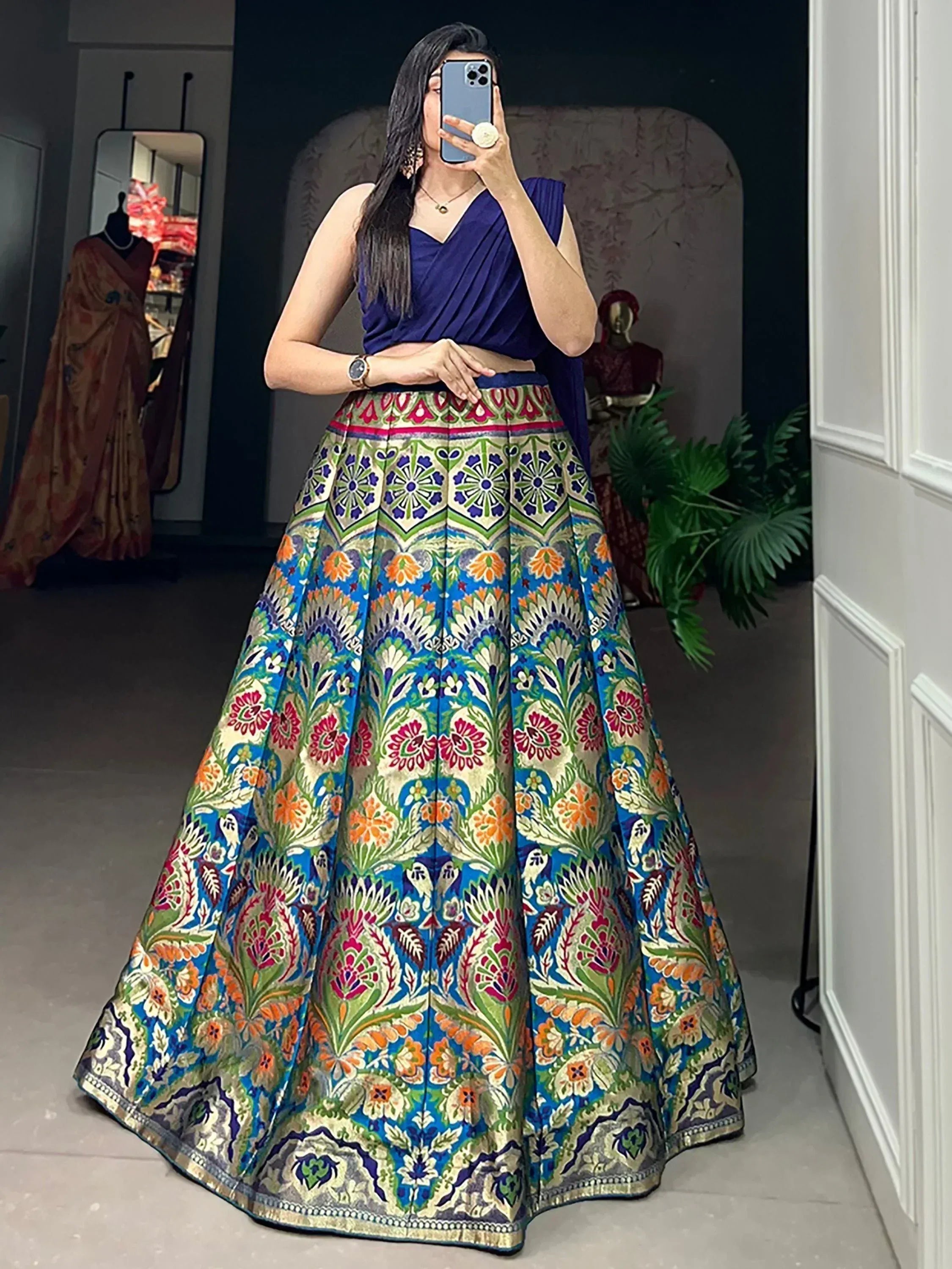 Woman in vibrant floral lehenga choli, Indian ethnic wear, mirror selfie, designer outfit
