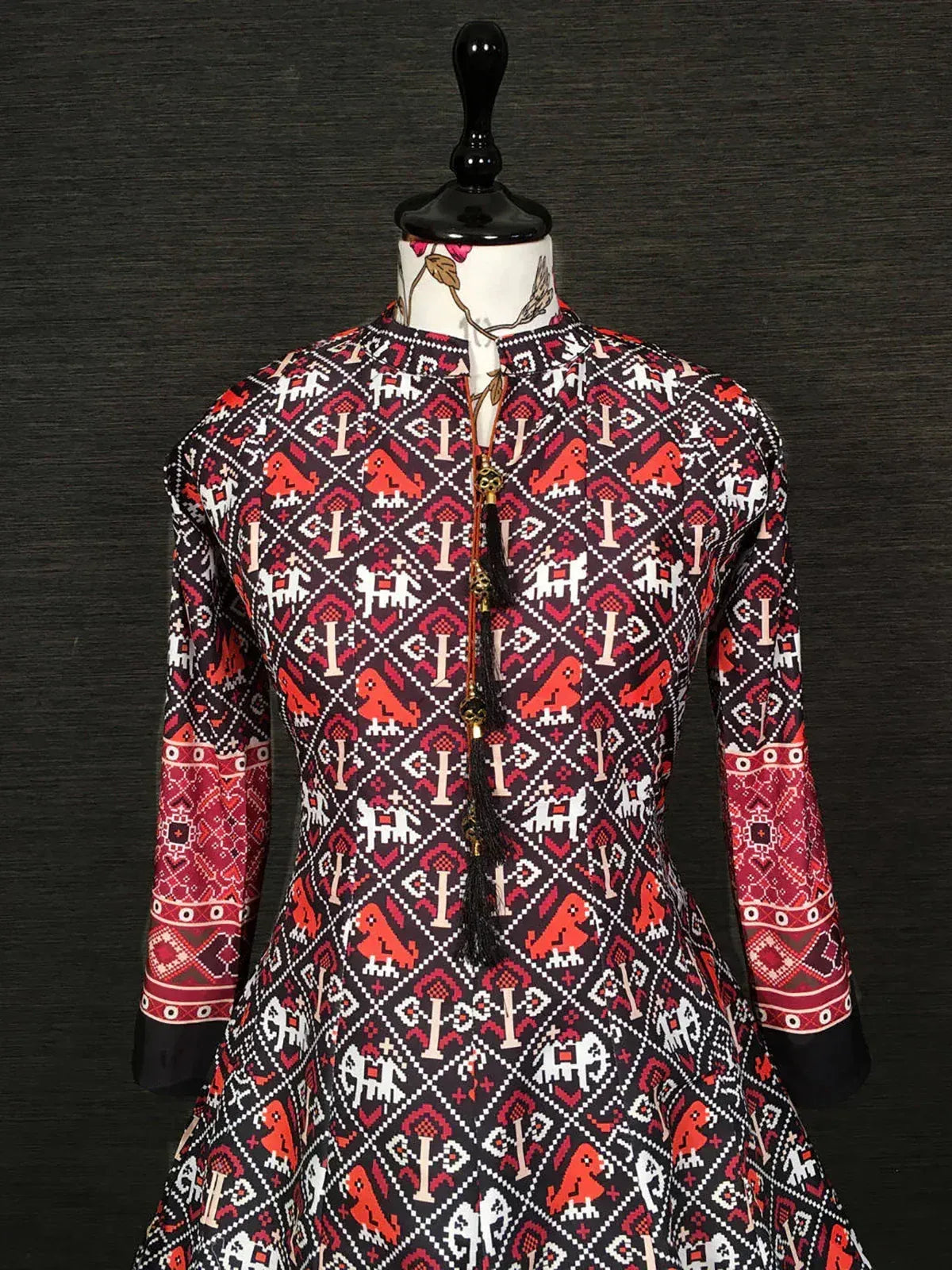 Black and red long-sleeve ethnic dress with traditional geometric and animal print