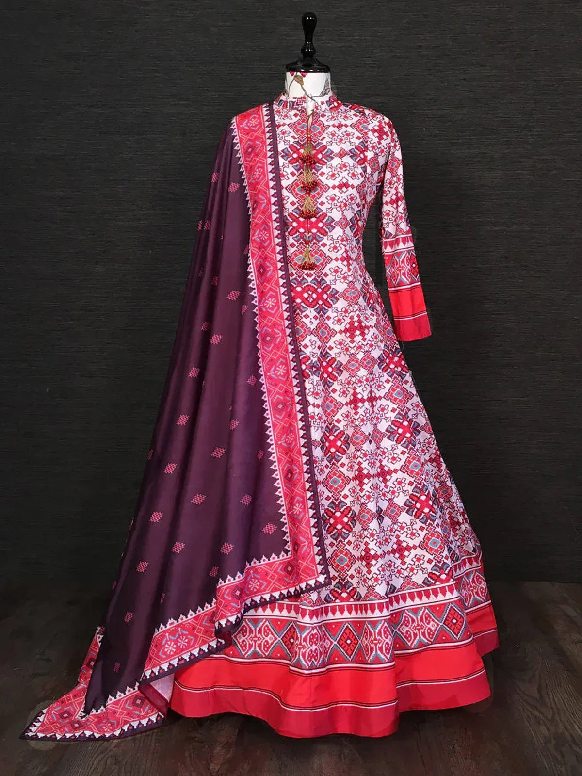 Red and white printed long ethnic gown with matching dupatta on mannequin
