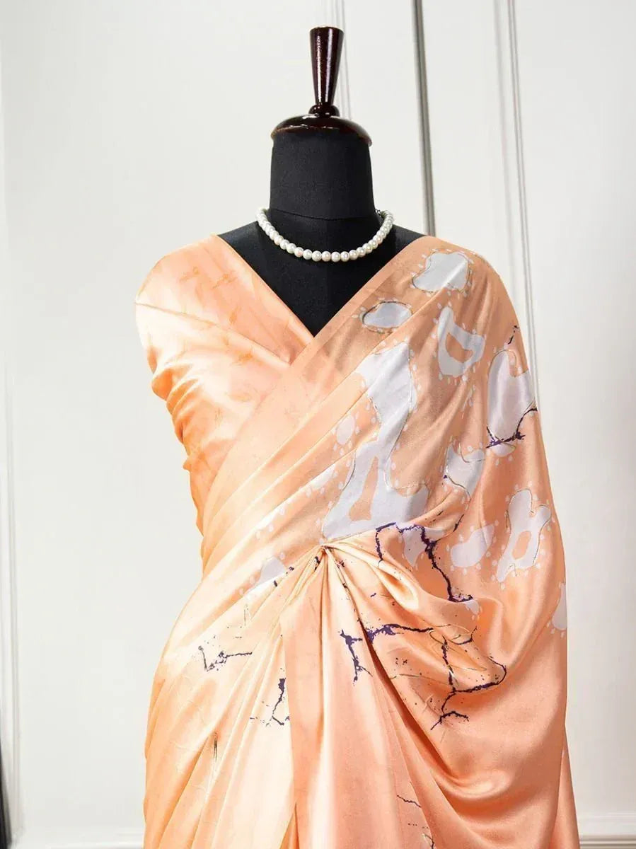 Peach satin saree with white and purple abstract print, styled on mannequin with pearl necklace