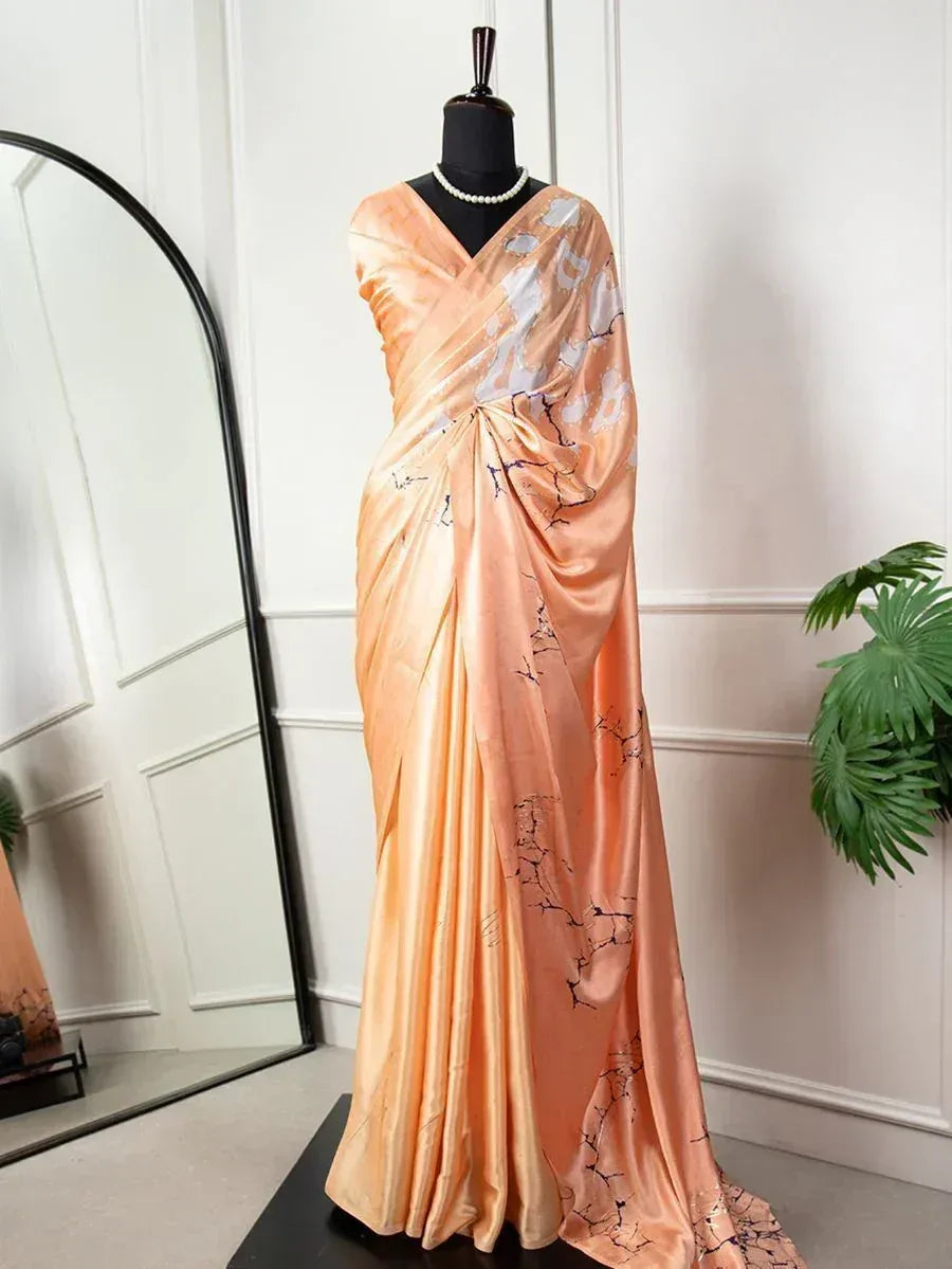 Peach satin saree with floral print, styled on mannequin for ethnic wear