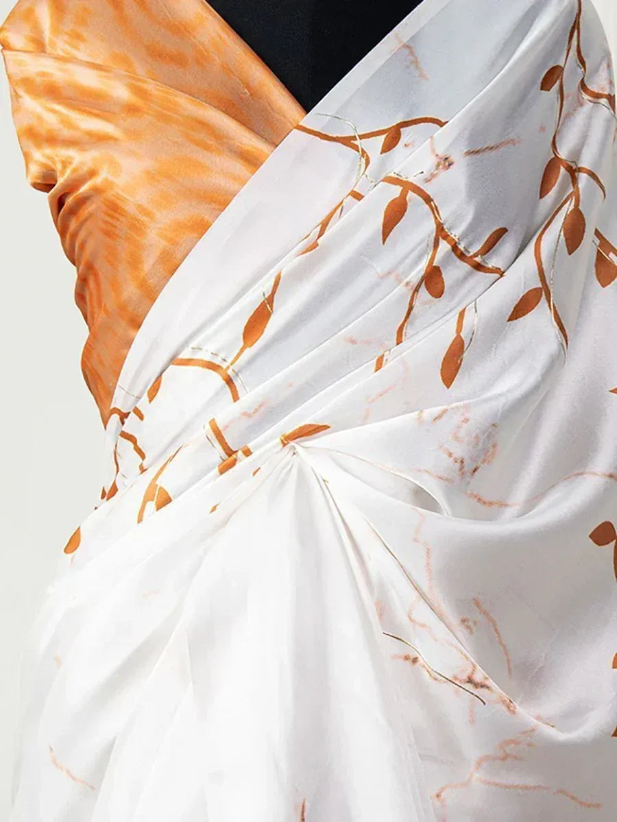 White saree with orange leaf print and tie-dye blouse, elegant ethnic wear for women