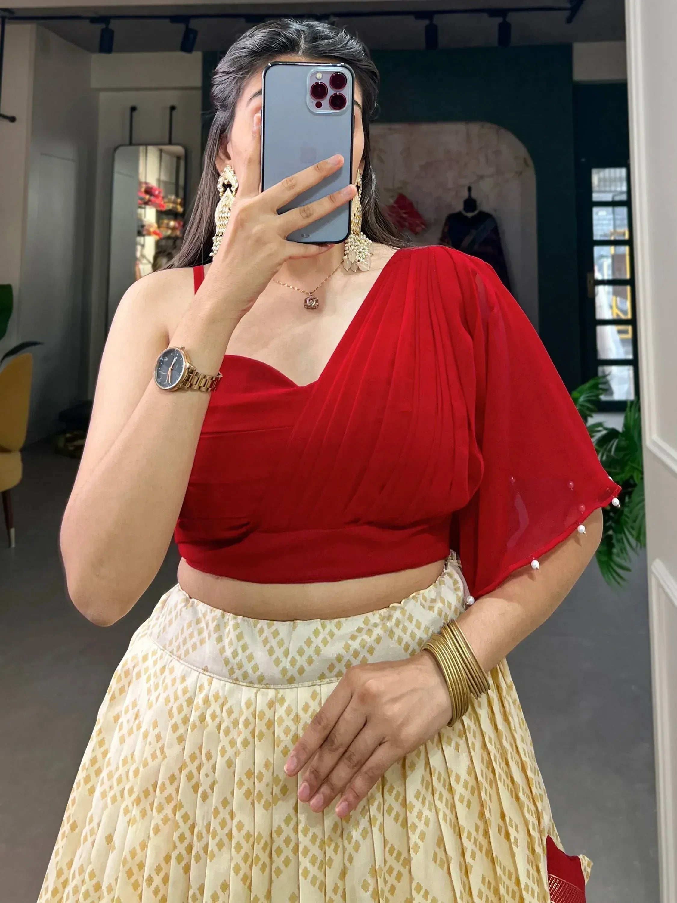 Red velvet crop top with sheer cape paired with printed lehenga skirt, ethnic Indian wear