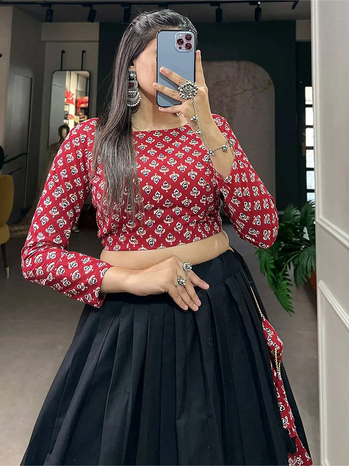 Red printed crop top with black pleated skirt, ethnic wear outfit