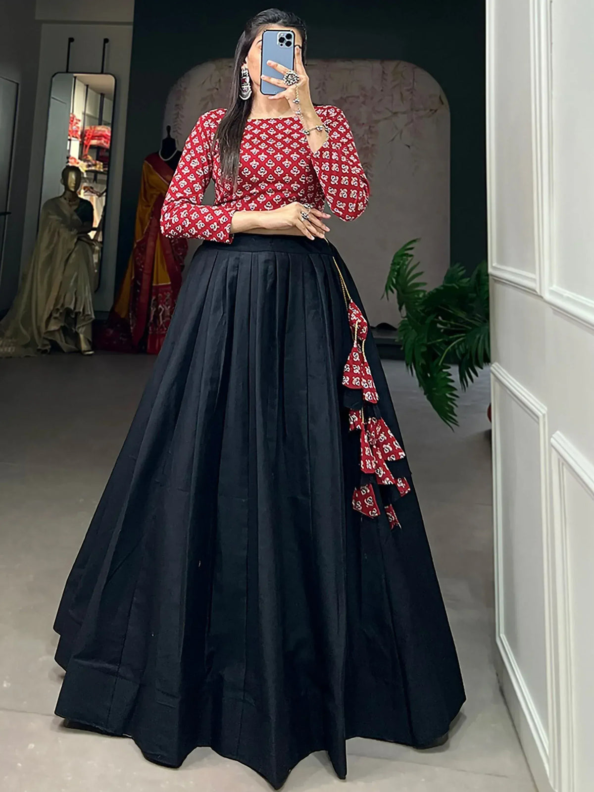Red printed blouse with black pleated lehenga, ethnic Indian wear for festive occasions