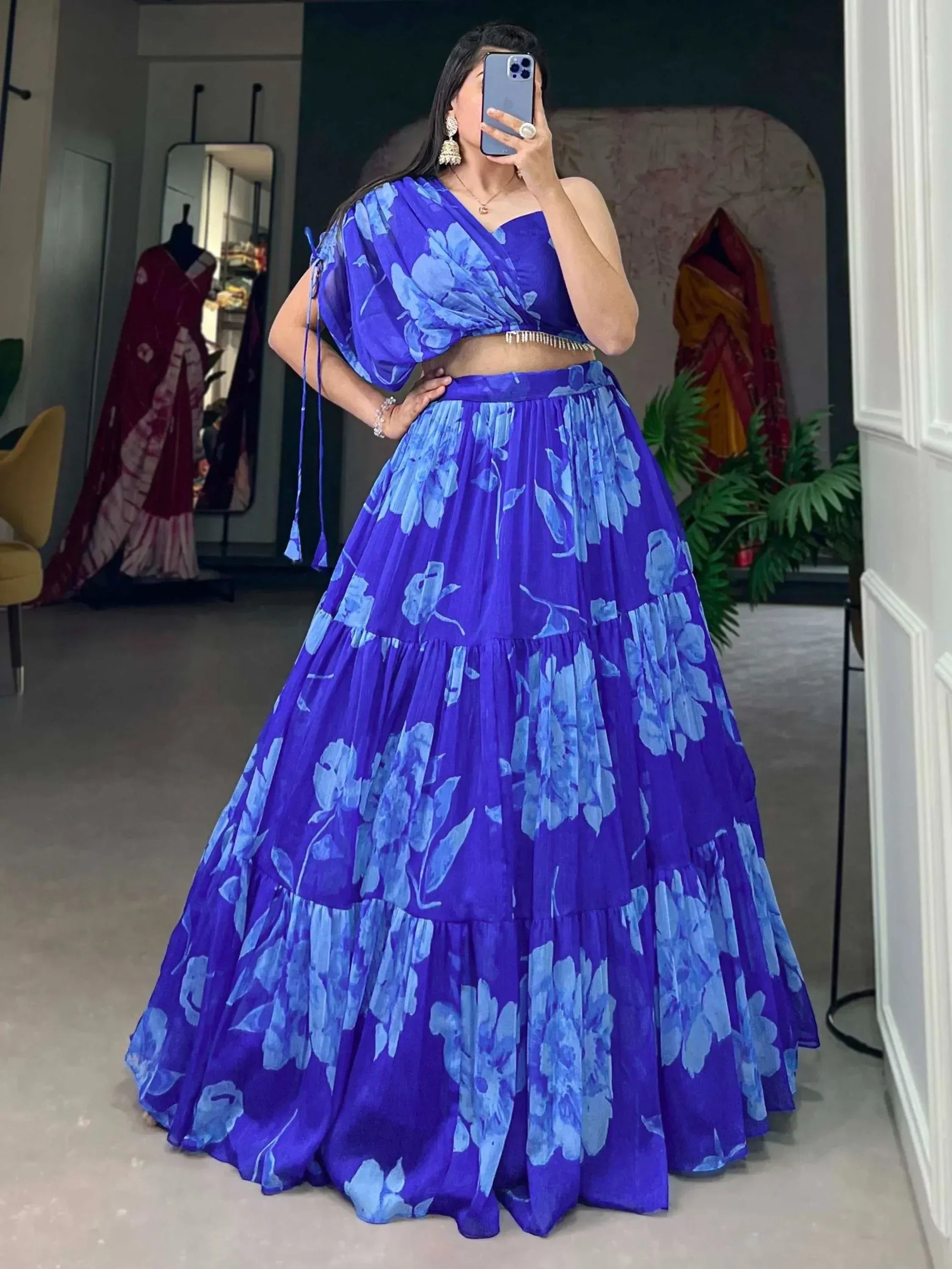 Blue floral lehenga choli with tiered skirt and draped top, perfect for Indian ethnic wear occasions.