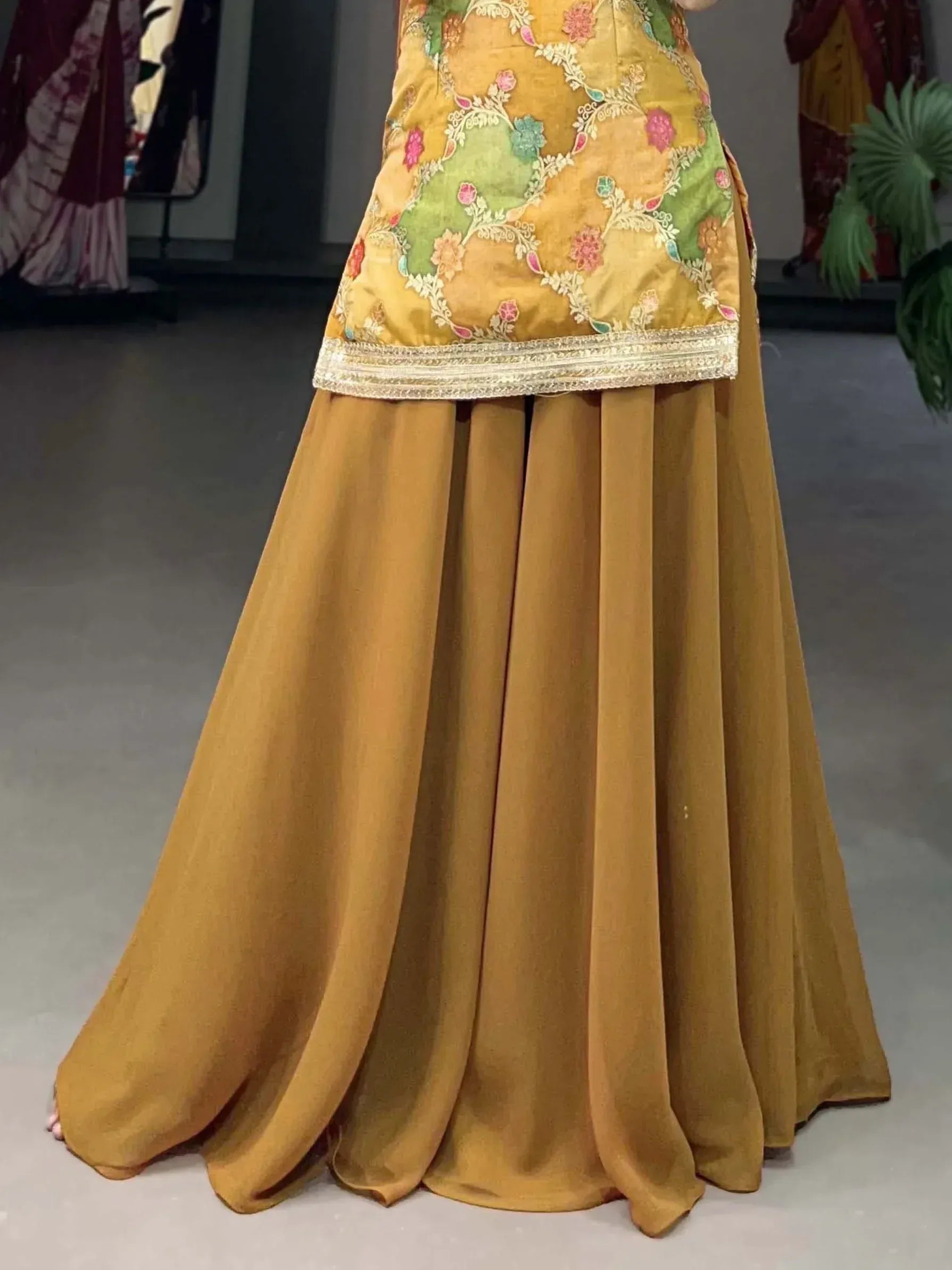 Mustard yellow ethnic gown with floral embroidery and pleated skirt, perfect for Indian occasions