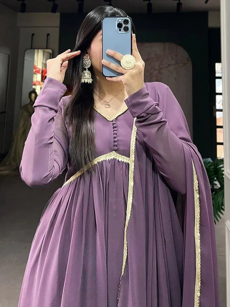 Purple ethnic gown with gold trim, long sleeves, and pleated skirt for women