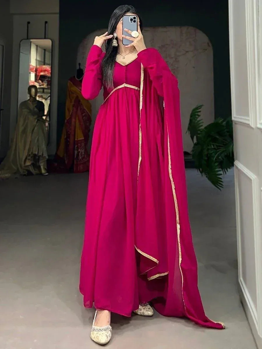 Vibrant pink ethnic gown with gold trim, perfect for Indian occasions and festive wear