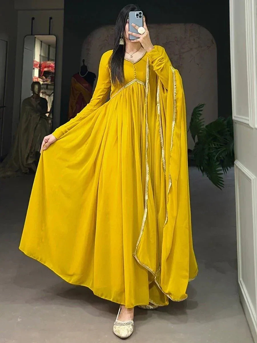 Vibrant yellow ethnic gown with gold trim, perfect for Indian occasions and festive wear.