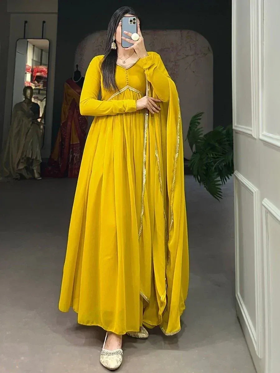 Vibrant yellow ethnic gown with gold trim, perfect for Indian occasions and festive wear.