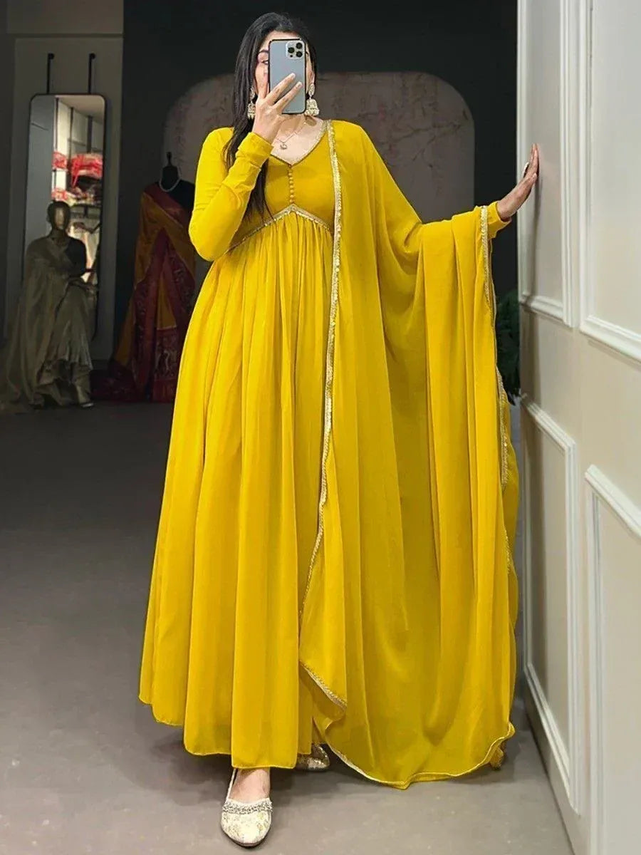 Vibrant yellow ethnic gown with gold trim, perfect for Indian occasions and festive wear.