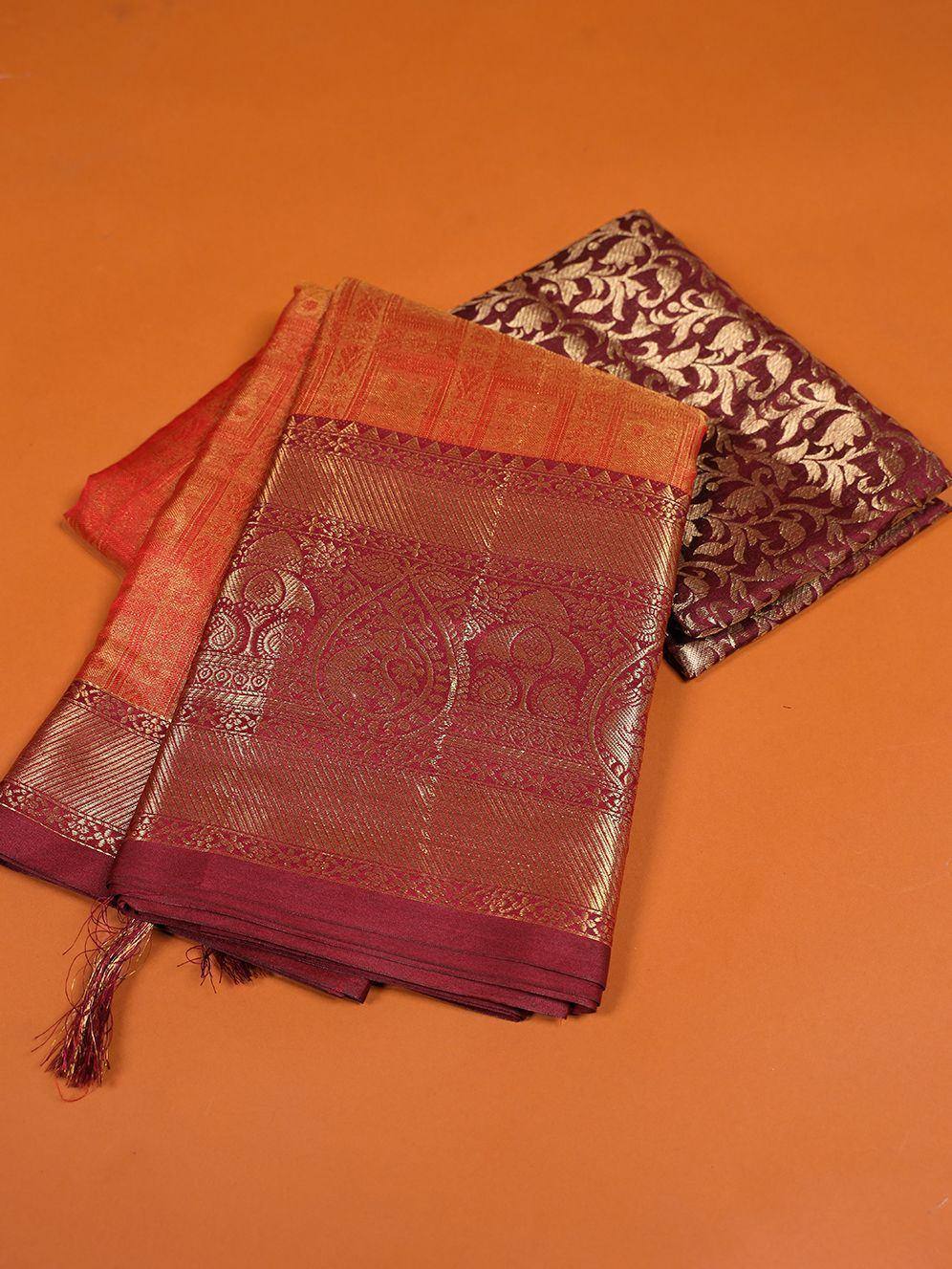 Rich maroon and gold ethnic saree with intricate woven patterns and tassels, perfect for festive occasions
