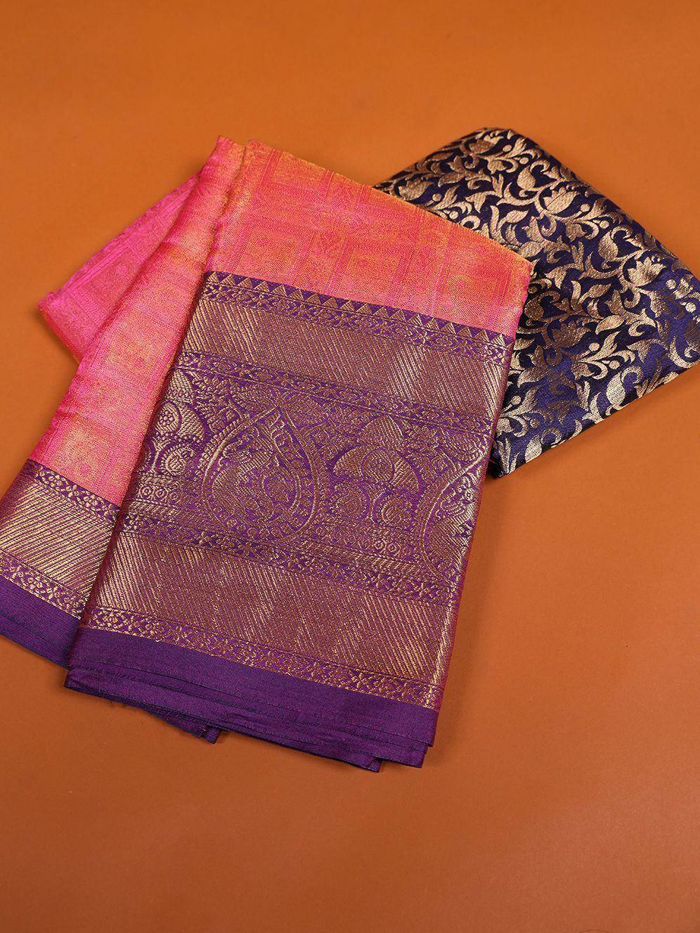 Elegant purple and pink designer saree with intricate golden patterns, perfect for ethnic occasions.