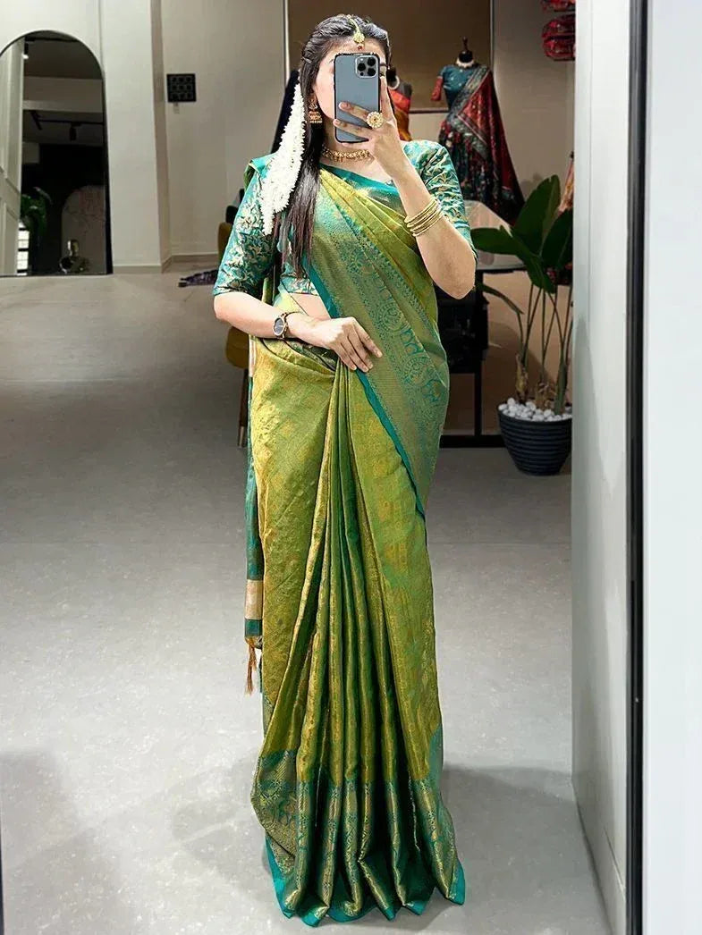 Woman in green and gold designer saree with blouse, traditional Indian ethnic wear