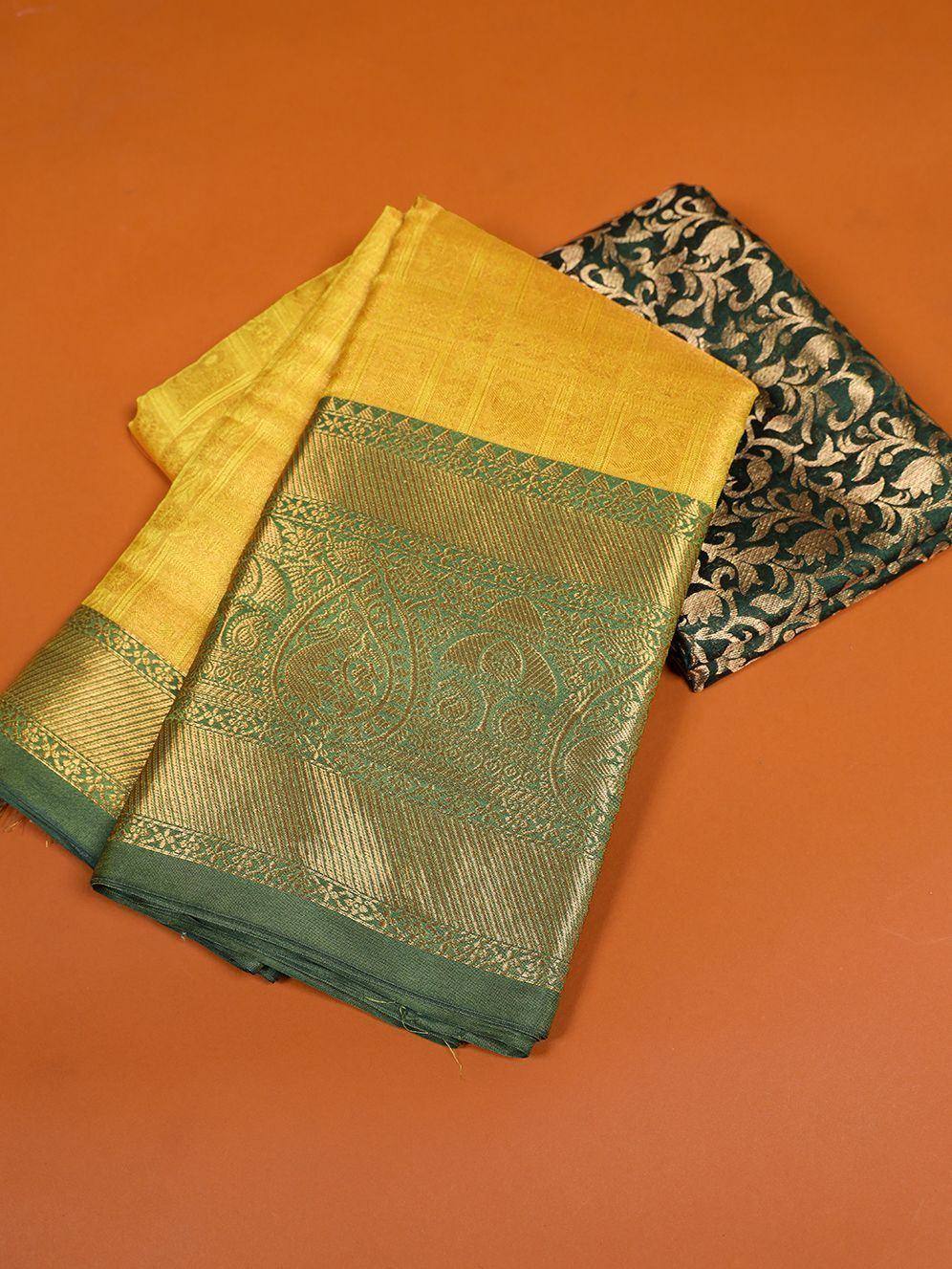 Yellow and green designer saree with intricate paisley border, paired with dark floral blouse fabric