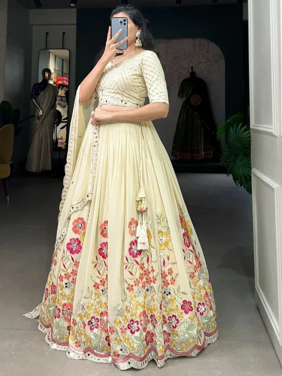 Cream floral embroidered lehenga choli with mirror work, perfect for Indian ethnic wear occasions.