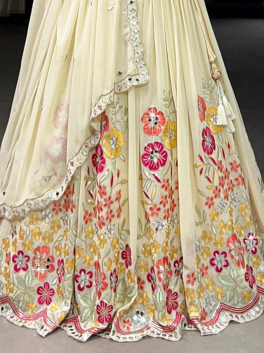 Cream floral embroidered lehenga with mirror work and tassels, Indian ethnic wear