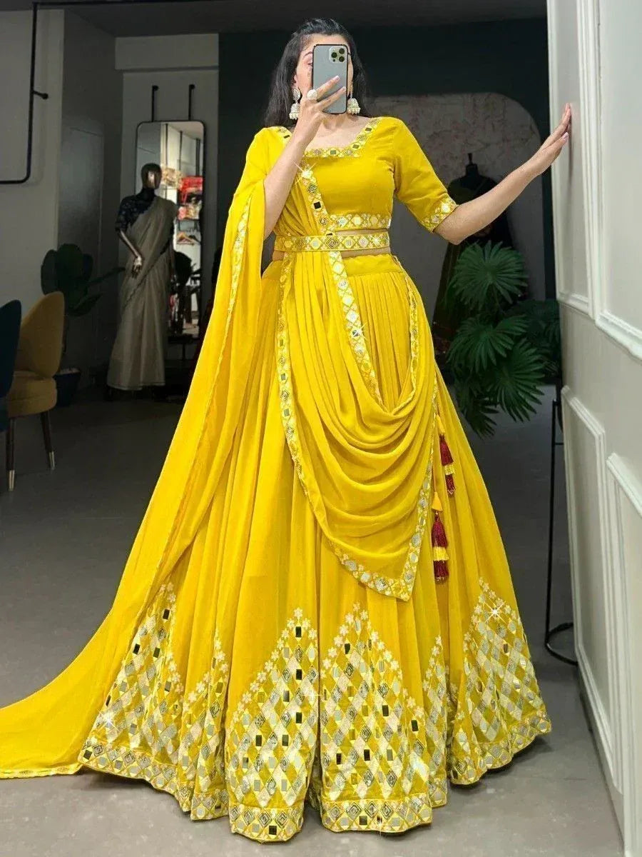 Vibrant yellow designer lehenga choli with mirror work and drape, perfect for Indian ethnic occasions