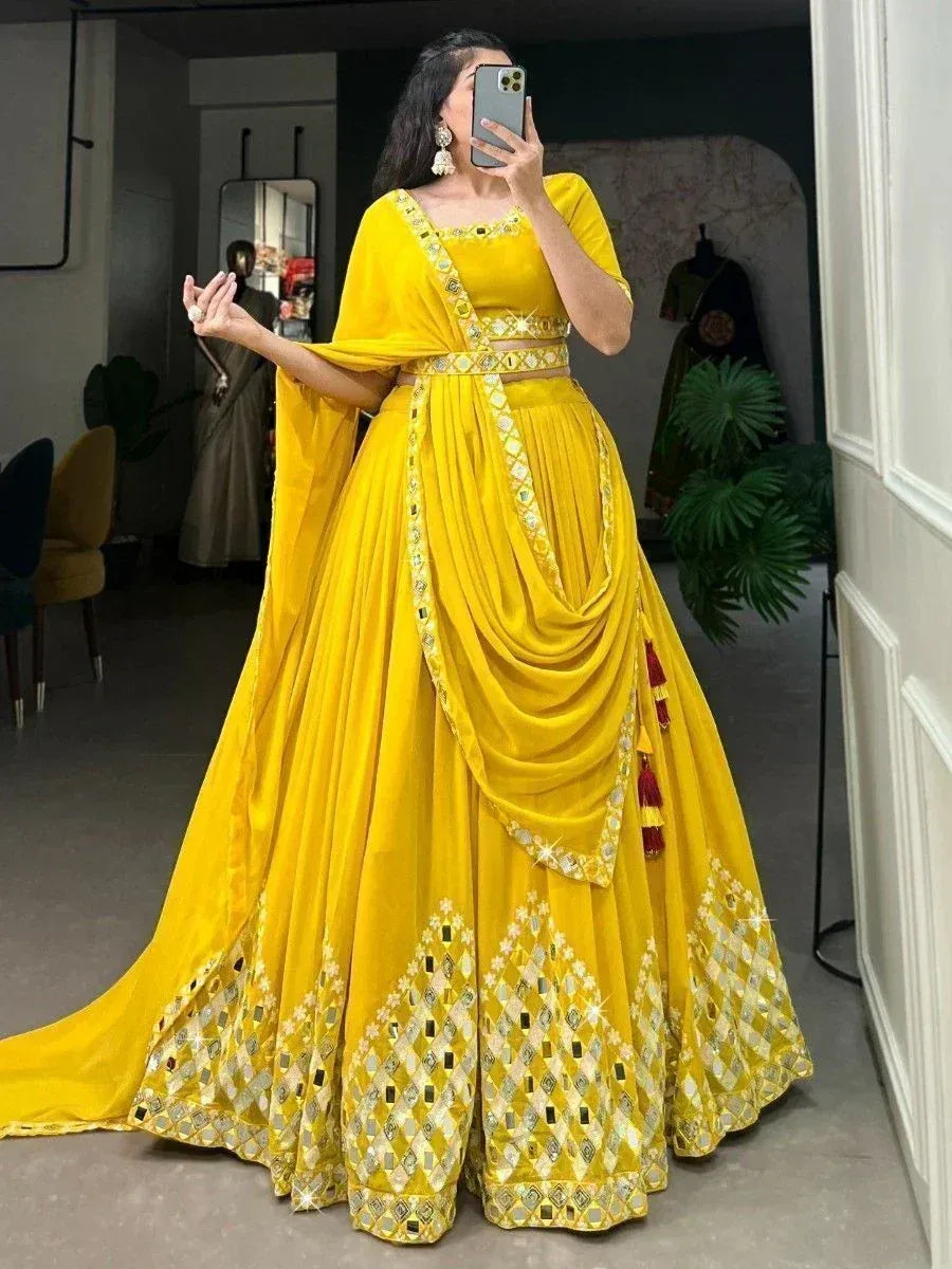 Vibrant yellow designer lehenga choli with mirror work and dupatta, perfect for Indian ethnic occasions