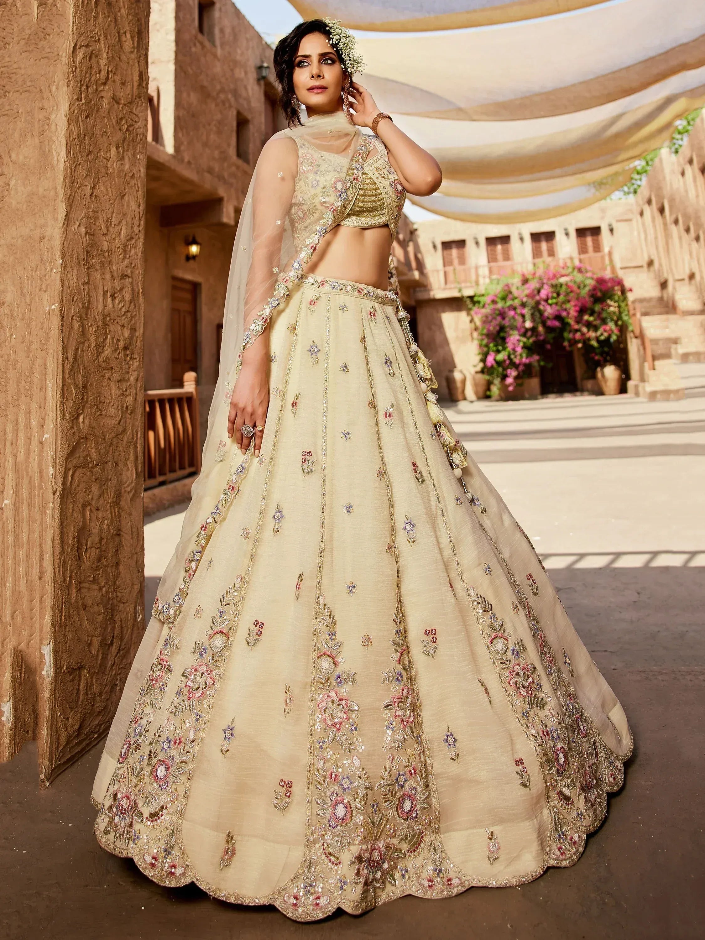 Elegant cream lehenga choli with floral embroidery, perfect for Indian weddings and festive occasions.
