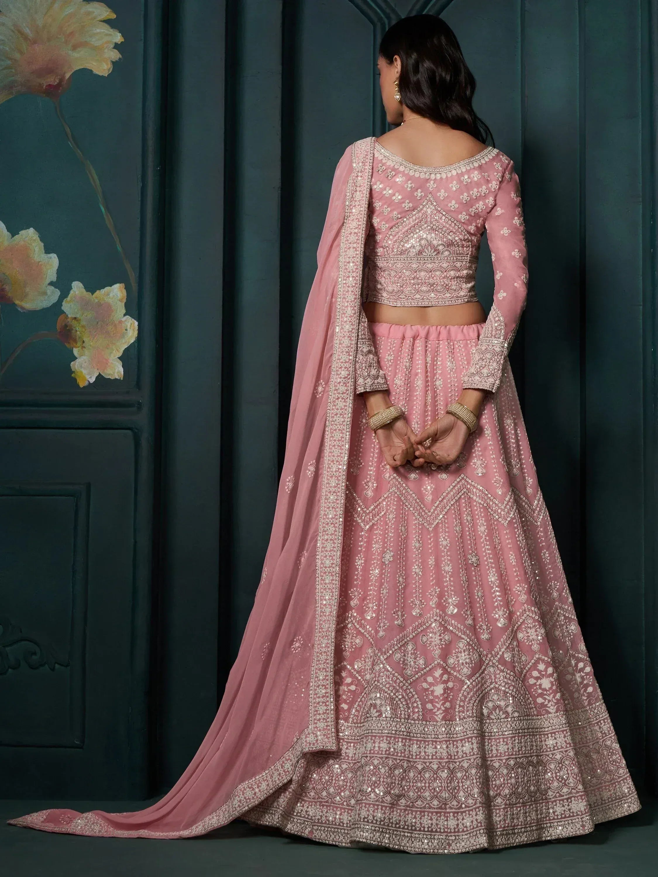 Pink embroidered lehenga choli with intricate designs and matching dupatta for ethnic wear