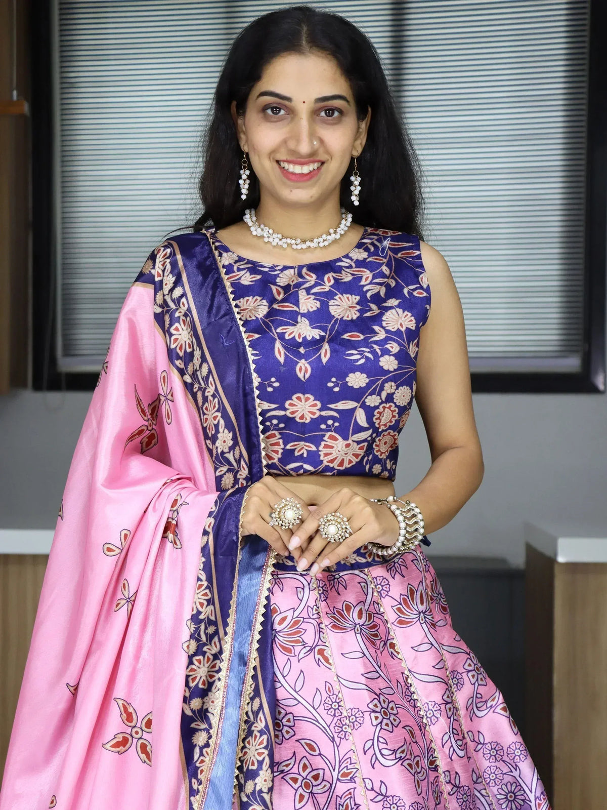 Woman in blue and pink floral lehenga choli with matching dupatta, perfect for Indian ethnic occasions.