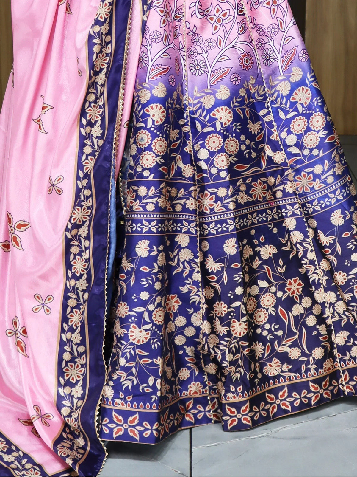 Pink and blue floral printed lehenga choli with intricate border design, ethnic Indian wear
